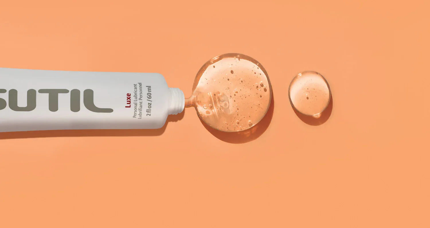 Sutil Luxe lube squeezed out displayed on an orange background