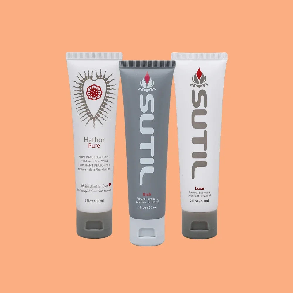SUTIL lube Rich, Luxe and Hathor pure in 2oz size displayed on an orange background