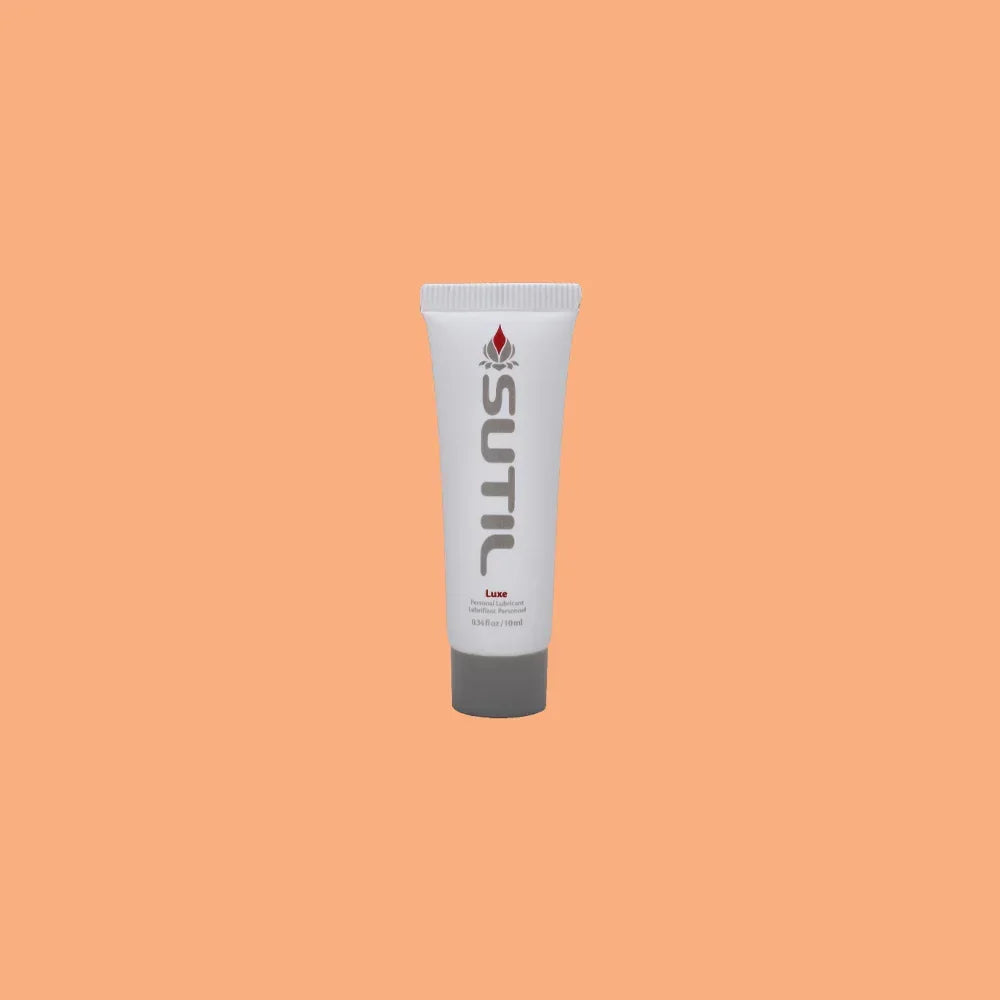 Mini Sutil Luxe Lube displayed over an orange background