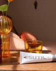 Sutil Luxe lube displayed on a bedside table