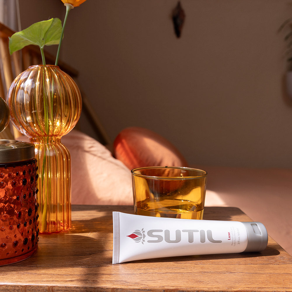 Sutil Luxe lube displayed on a bedside table